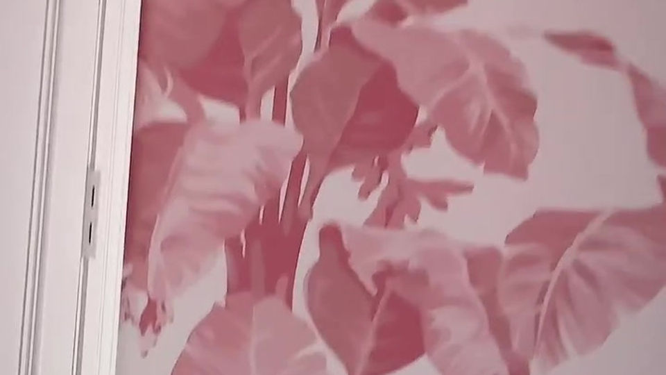 Pink wallpaper with foliage